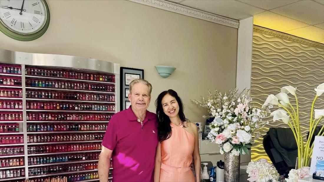 Rose and Gary Amole standing together at the front of Serenity Nails & Spa